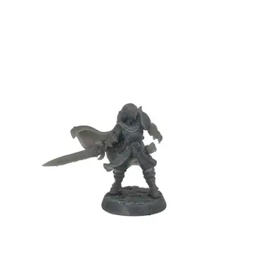 A front-view photograph of an unpainted grey resin fantasy commander miniature against a white background. The figure has shoulder-length hair and is wearing plate armor with a large pauldron on his left shoulder. He has a flowing cape blowing to his right and is holding a large, thick sword pointed outward in his right hand. He is standing on a textured cobblestone base.