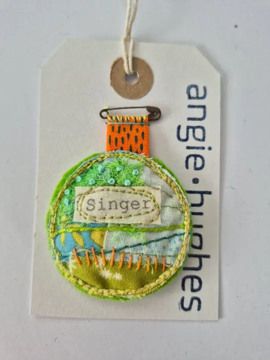 Singer Brooch