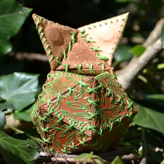 Handmade leather dice bag embossed with a tiny leaves.