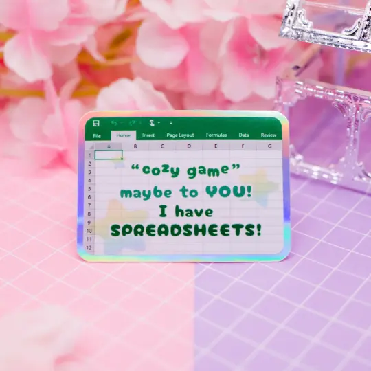 "Cozy game! Maybe to YOU! I have SPREADSHEETS!" holographic vinyl sticker
