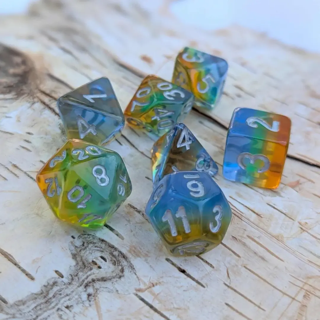 Cocktail Dice Set – 7-Piece Rainbow Layered Blue Green Yellow Orange Silver Font