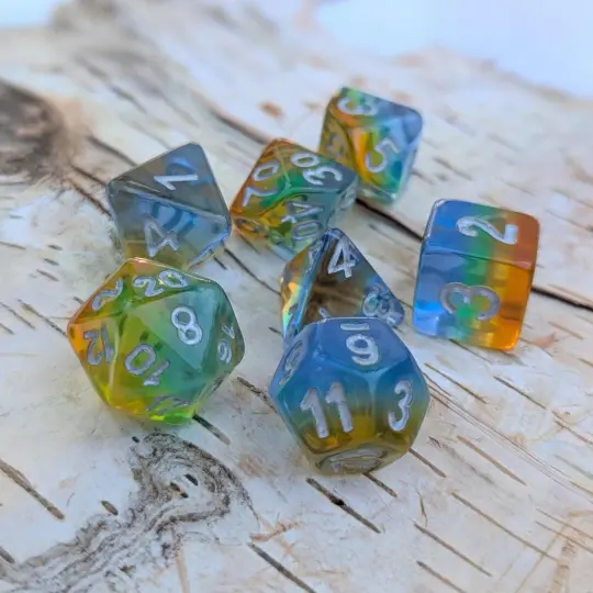 Cocktail Dice Set – 7-Piece Rainbow Layered Blue Green Yellow Orange Silver Font