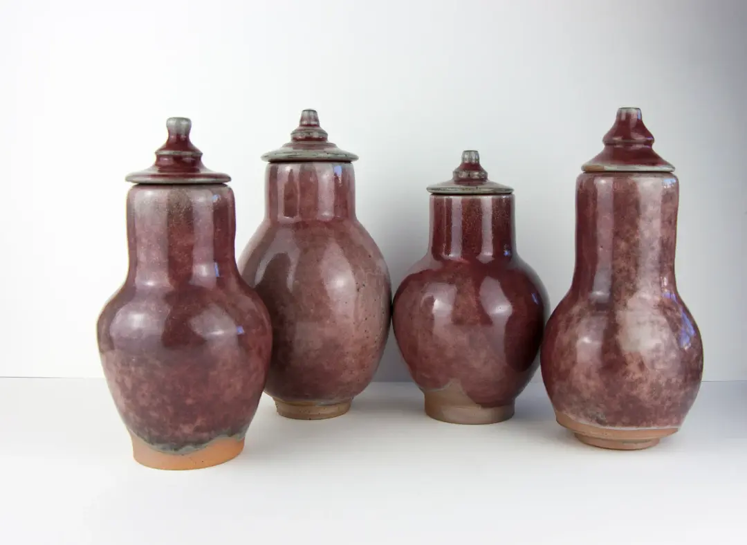 Four stoneware red vases