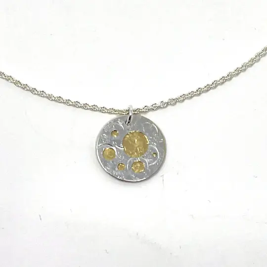 Silver and Brass Pierced Disc Necklace