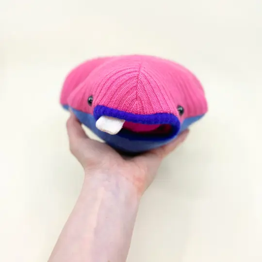 Bloopsy the pink plush sweater creature with pocket mouth