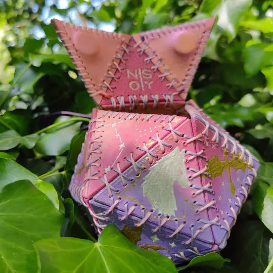 Handmade leather dice bag painted in pastel shades and decorated with gold and silver.