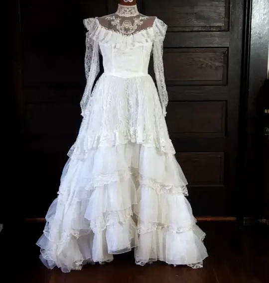 White lace square-neck long-sleeve ball gown with a cinched waist, vintage style and tiered cake skirt; bridal gown R7295