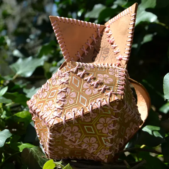 Leather dice bag embossed with a flower pattern