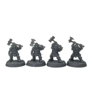 A front-view photograph of four unpainted grey resin goblin heavy infantry miniatures against a white background. The armored figures wear helmets and scale mail, and are posed dynamically with large weapons—two war hammers and two double-bladed axes—raised above their heads. They stand on circular cobblestone-textured bases.