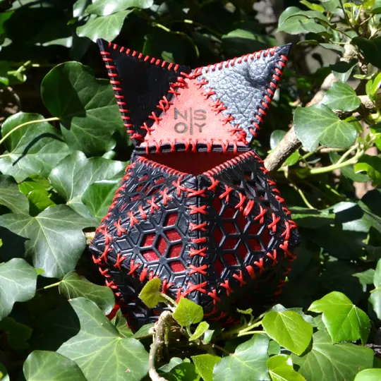 Handmade black leather dice bag with a geometric pattern and metallic leather.