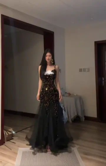 Sexy ball gown with black halter neck, fitted waist, and sequined fishtail skirt. R8065
