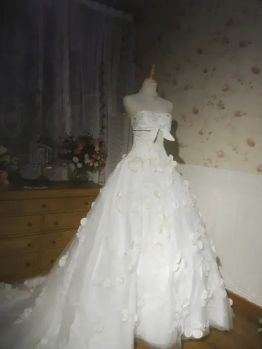 White strapless ball gown with a cinched waist and a voluminous puffy skirt; bridal gown R7291