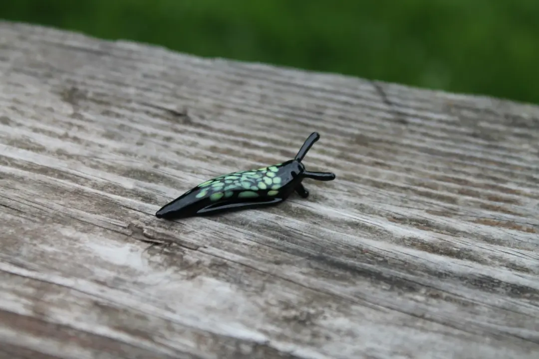 Miniature Black And Green Glass Slug Figurine For Nature Lovers